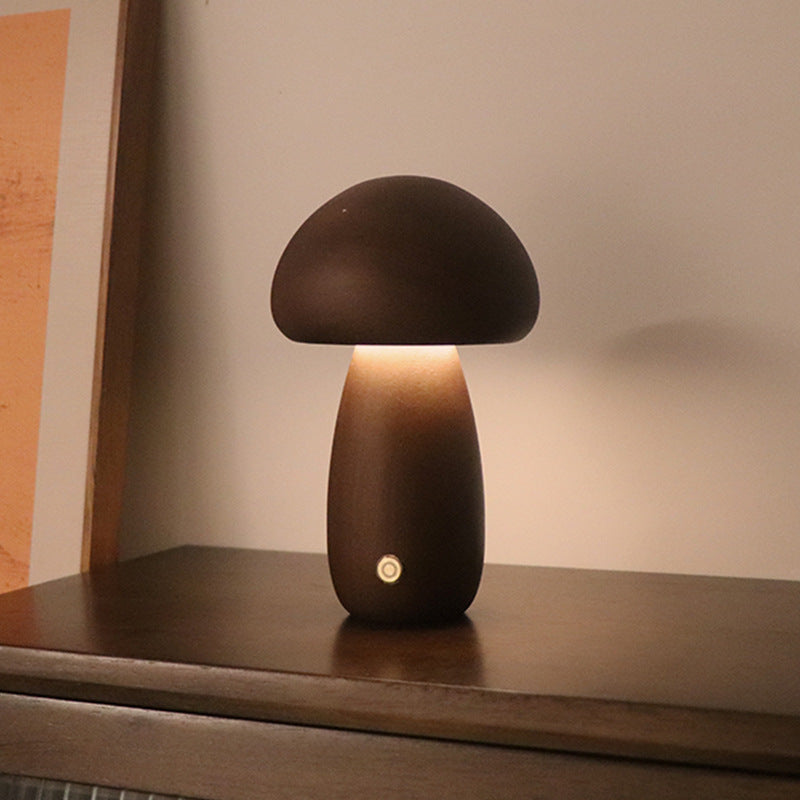 Wooden Mushroom LED Night Light featuring charming moss and jewelry accents. This creative and unique bedside table lamp adds a touch of nature-inspired warmth, perfect for bedroom or children's room decor. Crafted from beech/rubber wood, its personality-driven design enhances the ambiance with a blend of mushroom charm, mossy allure, and delicate jewelry detailing. Bring home this limited edition night light today for a touch of whimsical elegance in every corner.